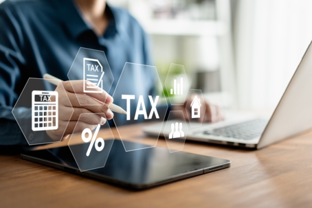 E-Filing, Taxpayer using a laptop to file taxes personal income, Tax Return form online for tax payment. Government, state taxes. Data analysis, paperwork, reports. Calculation tax return.
